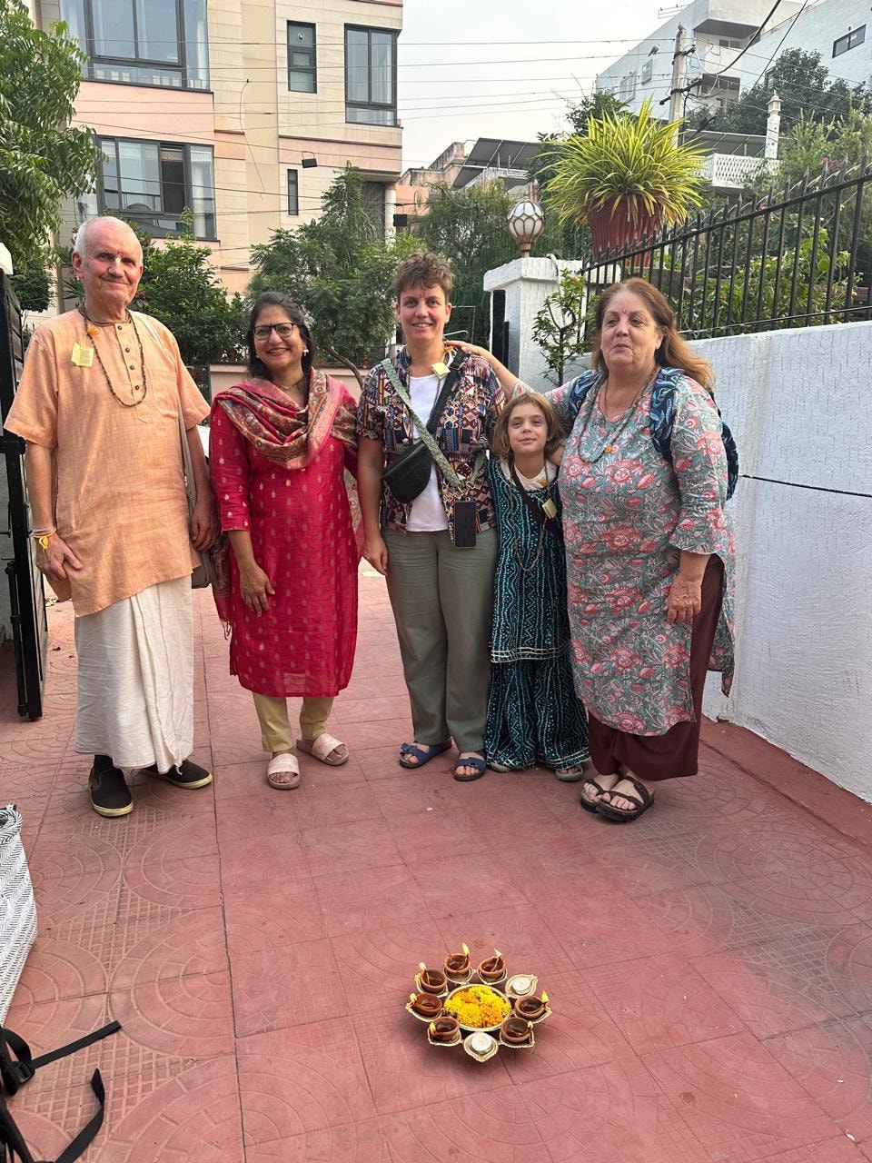 Diwali festival welcome — guests with hosts and diyas