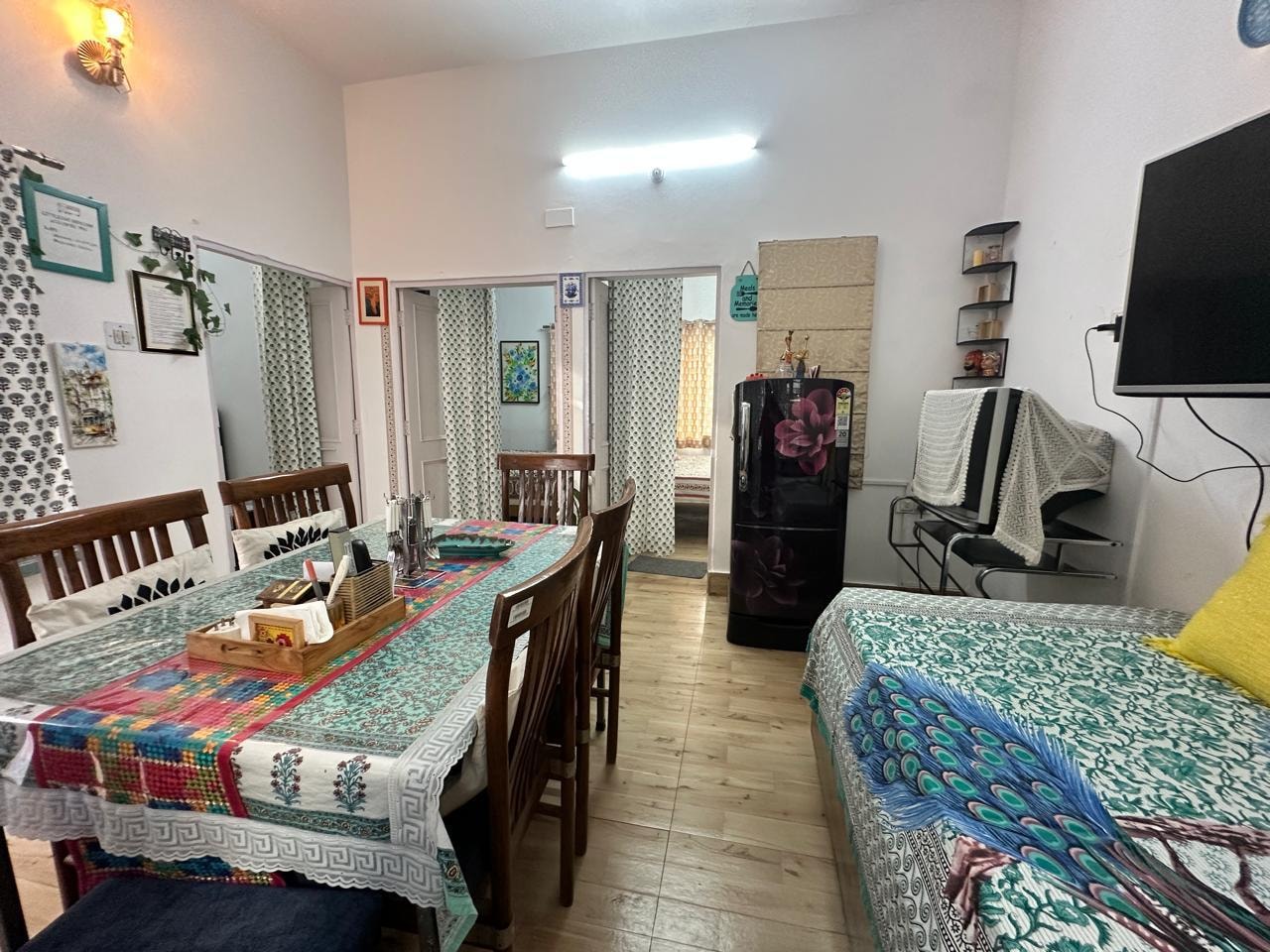 Dining and sitting area with colourful block-print textiles